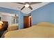 Comfortable bedroom with blue accent wall, featuring a large bed and mirrored closet at 2656 Whisper Lakes Club Cir, Orlando, FL 32837