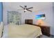Cozy bedroom with neutral walls, wood furnishings, and a ceiling fan, creating a relaxing space at 2656 Whisper Lakes Club Cir, Orlando, FL 32837