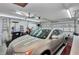 Well-lit garage with ample storage, pegboard, and a car, offering convenient parking and organization at 2656 Whisper Lakes Club Cir, Orlando, FL 32837