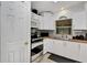 Bright kitchen features stainless steel appliances, white cabinets, wood counters and a tiled backsplash at 2656 Whisper Lakes Club Cir, Orlando, FL 32837