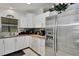 Bright kitchen featuring stainless steel appliances, white cabinetry, wood counters, and tile flooring at 2656 Whisper Lakes Club Cir, Orlando, FL 32837