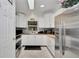 Modern kitchen with stainless steel appliances and white cabinets at 2656 Whisper Lakes Club Cir, Orlando, FL 32837