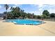 A community swimming pool with trees and lounge chairs with a 5ft 6in shallow end and a 7ft deep end at 2656 Whisper Lakes Club Cir, Orlando, FL 32837