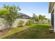 Well-maintained backyard with lush green grass, mature trees, and a privacy fence, perfect for outdoor activities at 2723 Forestdale St, St Cloud, FL 34771