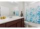 Well-maintained bathroom with a single sink vanity and a shower with a patterned curtain at 2723 Forestdale St, St Cloud, FL 34771
