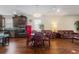 Dining area featuring a wooden table, leather chairs, and an open connection to the modern kitchen at 2723 Forestdale St, St Cloud, FL 34771