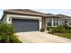 Charming home featuring a gray garage door, well-maintained landscaping, and a welcoming exterior with a bay window at 2723 Forestdale St, St Cloud, FL 34771