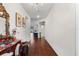 Elegant hallway featuring dark hardwood floors, a chandelier, and tasteful decorations at 2723 Forestdale St, St Cloud, FL 34771