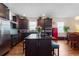 Modern kitchen with dark cabinetry, a central island, stainless steel appliances, and stylish accents at 2723 Forestdale St, St Cloud, FL 34771