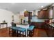 Spacious kitchen with dark cabinets, granite countertops, a large island with seating, and stainless appliances at 2723 Forestdale St, St Cloud, FL 34771