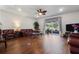 Comfortable living room with hardwood floors, sliding glass doors, and a stylish ceiling fan at 2723 Forestdale St, St Cloud, FL 34771