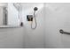 Modern shower with white tiled walls and built-in niche for toiletries, offering a clean and functional space at 2723 Forestdale St, St Cloud, FL 34771