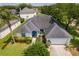 Aerial view of well-maintained single-story home with lush green lawn and landscaped front yard at 2745 University Acres Dr, Orlando, FL 32817