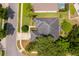 Birds-eye view of roof and the lot, with lush trees, and surrounding neighborhood at 2745 University Acres Dr, Orlando, FL 32817