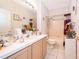 Bathroom with a tub, single sink vanity, and neutral tile flooring at 2745 University Acres Dr, Orlando, FL 32817
