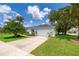 Charming single-story home with well-maintained landscaping, green lawn and driveway at 2745 University Acres Dr, Orlando, FL 32817