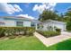 Charming single-story home with well-maintained landscaping, green lawn and sidewalk at 2745 University Acres Dr, Orlando, FL 32817