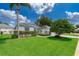 Charming single-story home with well-maintained landscaping, lush green lawn and sidewalk at 2745 University Acres Dr, Orlando, FL 32817