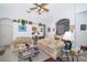 Bright living room featuring comfortable seating, a ceiling fan, and an open layout to the kitchen at 2745 University Acres Dr, Orlando, FL 32817