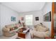 Comfortable living room with neutral tones, plush sofas, and a large window at 2745 University Acres Dr, Orlando, FL 32817