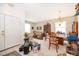 Bright living room featuring tiled floors, furniture, and a front door view at 2745 University Acres Dr, Orlando, FL 32817