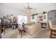 Bright and airy living room with a ceiling fan, comfortable seating, and large windows at 2745 University Acres Dr, Orlando, FL 32817