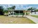 Charming, single-story home featuring a covered porch, carport, and well-kept landscaping at 2808 Drake Dr, Orlando, FL 32810