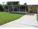 Charming single-story home featuring a covered porch, a well-manicured lawn, and a private driveway at 2808 Drake Dr, Orlando, FL 32810