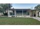 Charming single-story home featuring a covered porch, a well-manicured lawn, and a private driveway at 2808 Drake Dr, Orlando, FL 32810