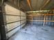 Spacious garage interior with an open door, built-in shelves, and natural light at 2808 Drake Dr, Orlando, FL 32810