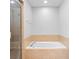 Inviting soaking tub with tile surround, perfect for relaxation at 2829 Shady Willow Ln, Oviedo, FL 32765