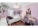 A whimsical bedroom featuring a decorated wall and a ceiling fan at 2829 Shady Willow Ln, Oviedo, FL 32765