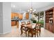 Inviting dining area adjacent to the kitchen with wood cabinets and sliding glass doors to a green backyard at 2829 Shady Willow Ln, Oviedo, FL 32765