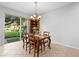 Bright dining area with a wooden table set, tile flooring, and sliding glass doors opening to the backyard at 2829 Shady Willow Ln, Oviedo, FL 32765
