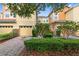 Charming townhome showcasing a two-car garage, well-kept landscaping, and brick-paved driveway at 2829 Shady Willow Ln, Oviedo, FL 32765