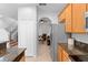 Bright kitchen with stainless steel appliances and granite countertops, leading to a cozy living area with stairs at 2829 Shady Willow Ln, Oviedo, FL 32765