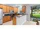 Bright kitchen with stainless appliances, granite countertops, and a breakfast bar overlooking the yard at 2829 Shady Willow Ln, Oviedo, FL 32765