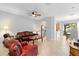 Bright living room featuring tile flooring, a ceiling fan, and archway into kitchen at 2829 Shady Willow Ln, Oviedo, FL 32765