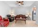 Comfortable living room featuring ceiling fan and neutral tile flooring at 2829 Shady Willow Ln, Oviedo, FL 32765