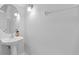 Clean powder room with a pedestal sink, oval mirror, and neutral paint, offering simple elegance at 2829 Shady Willow Ln, Oviedo, FL 32765