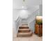 Well-lit staircase with neutral carpet, white railings, and a view of a decorative cabinet on the landing at 2829 Shady Willow Ln, Oviedo, FL 32765