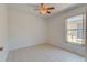 Bright bedroom featuring tile floors, ceiling fan, and a window at 289 N Wilderness Pt, Casselberry, FL 32707