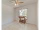 Bright bedroom featuring tile floors, ceiling fan, and a window at 289 N Wilderness Pt, Casselberry, FL 32707