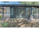 Exterior view displays screened-in porch with brick and foliage, and glass doors leading inside at 289 N Wilderness Pt, Casselberry, FL 32707