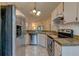 Well-lit kitchen with stainless steel appliances and stone countertops at 289 N Wilderness Pt, Casselberry, FL 32707