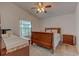 Comfortable bedroom features a window view, dresser and bedside table at 289 N Wilderness Pt, Casselberry, FL 32707