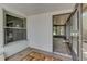 The screened porch showcases a colorful carpet, a window, and a door opening to an outdoor area at 289 N Wilderness Pt, Casselberry, FL 32707