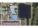 Aerial view of community pool, tennis courts, clubhouse, and lake with homes nearby at 2999 Buccaneer Palm Rd, Kissimmee, FL 34747