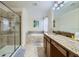Luxurious bathroom with walk-in shower, soaking tub, and granite-topped double vanity at 2999 Buccaneer Palm Rd, Kissimmee, FL 34747