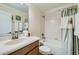 Bright bathroom featuring a shower and tub combo with decorative shower curtain and white countertops at 2999 Buccaneer Palm Rd, Kissimmee, FL 34747